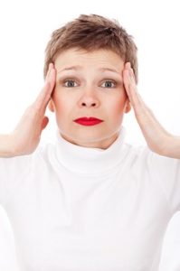 woman holding head