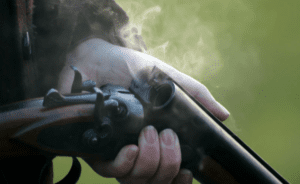 holding a shotgun